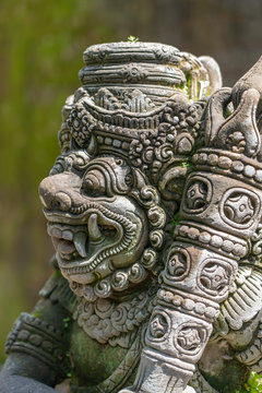 Traditional stone statue depicting demon, god and Balinese mythological deities in Ubud, island Bali, Indonesia