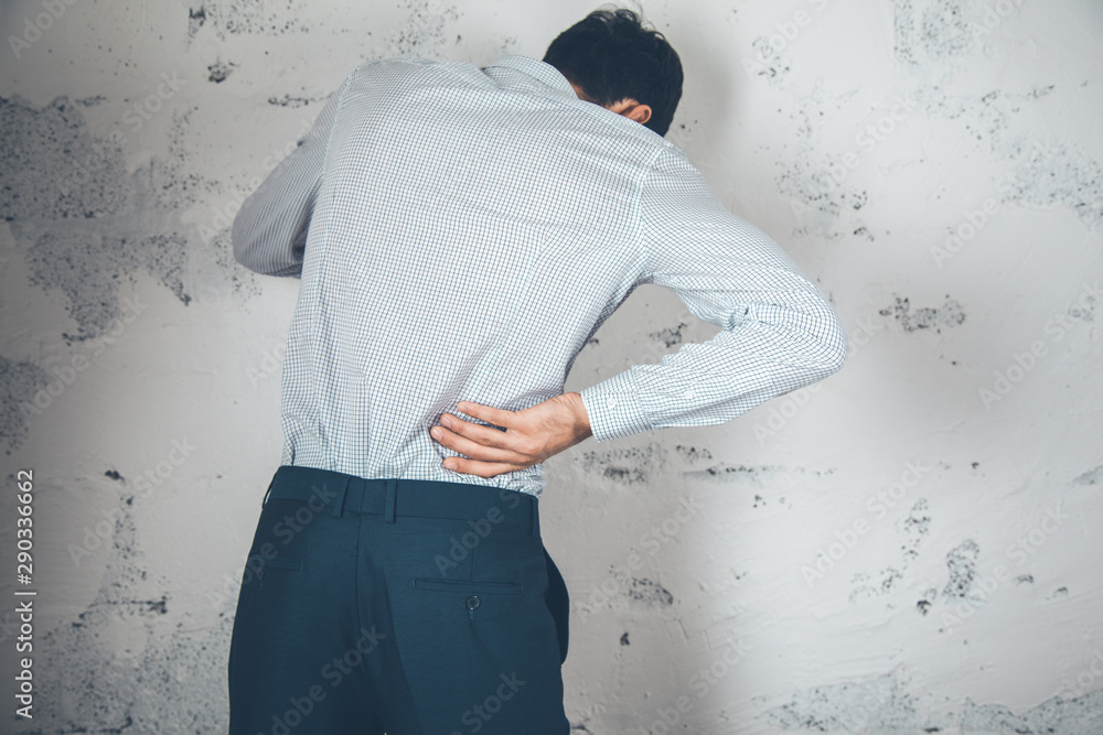 Poster man hand in ache back on abstract background
