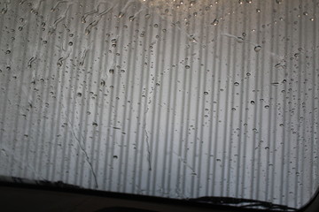 car wash. Clean and wash the car window. Drops of water on the glass