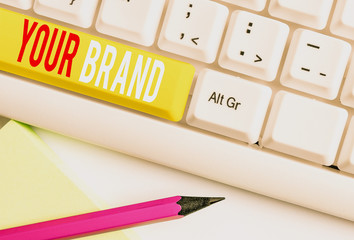 Handwriting text writing Your Brand. Conceptual photo A name of any kind that is impacted to something as trademark White pc keyboard with empty note paper above white background key copy space