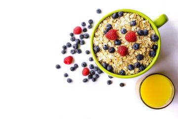 Oatmeal and fresh berries isolated on a white background.