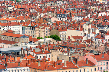 Fototapeta na wymiar Red roofs and stone chimneys are the traditional architecture of the historic center of the french city of Lyon as well as many old European towns
