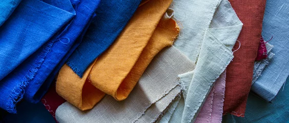 Keuken spatwand met foto Een stapel kleurrijke stoffenachtergrond. Veelkleurige linnen stof © v_sot