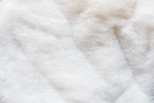 The texture of a white padding polyester. Syntepon- insulation material for clothes