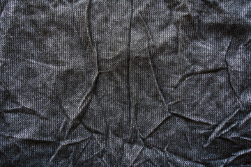 Crumpled black fabric texture. Clothing materials background