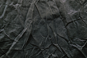 Crumpled black fabric texture. Clothing materials background