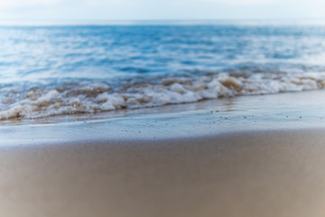 Beautiful waves rolling up on a sandy beach. Summertime in Österlen, Sweden.