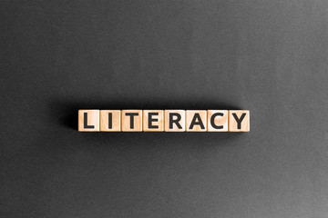 literacy - word from wooden blocks with letters, basic skill or knowledge literacy concept, random...