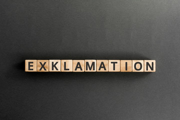 exclamation - word from wooden blocks with letters, express surprise or shock exclamation  concept,  top view on grey background
