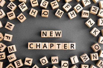 new chapter - words from wooden blocks with letters, starting new life new chapter concept, random...