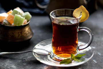 Arabic, oriental tea with lemon. Warms on cold evenings, cools in the hot summer. Heals colds. Nearby lies a fresh root and lime green.