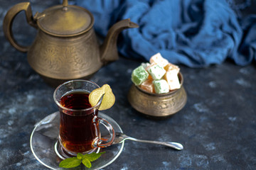 Arabic, oriental tea with lemon. Warms on cold evenings, cools in the hot summer. Heals colds. Nearby lies a fresh root and lime green.
