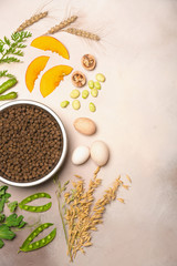 Special vegetarian pet food and natural raw ingredients on light grey background. Flat lay.