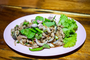 Close up spicy minced beef salad with fresh mint and chili