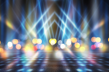 Abstract background. Dark empty stage, multi-colored rays of a neon searchlight, wet asphalt,...
