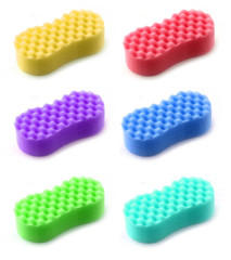 Set of sponges in different colors for washing dishes on a white background. The sponge has a knurled surface. It can be used for household and car wash.