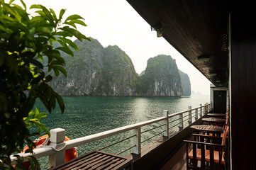 A tourists vessel in the karst landscape of Hạ Long Bay, Quảng Ninh Province, Vietnam. Hạ Long Bay is a UNESCO World Heritage Site.