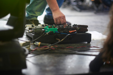 Obraz premium guitar pedalboard been adjusted by guitarist