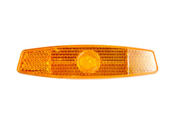 Bicycle wheel reflector isolated on white background. Orange plastic reflector which is mounted on a bike spoke for safety at night