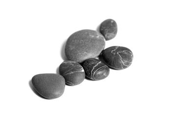 Scattered sea pebbles. Heap of smooth gray and black spa stones isolated on white background