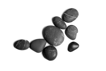 Fototapeta na wymiar Scattered sea pebbles. Heap of smooth gray and black spa stones isolated on white background