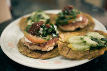 fried plantain burgers made with chicken patties and using fried plantains as buns. traditional all over the caribbean