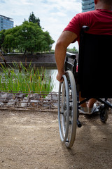 Detail of a disabled man on a wheelchair enjoying time outdoors in a park