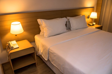 White comfortable pillow on bed decoration interior of hotel bedroom