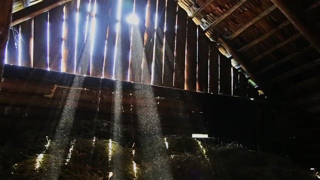 Slow movement of dust on the light rays of the sun in the attic of the old barn HD 1920x1080