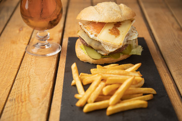 Cheeseburger with potatoes and beer