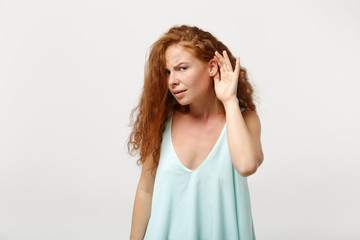 Young curious redhead woman girl in casual light clothes posing isolated on white wall background....
