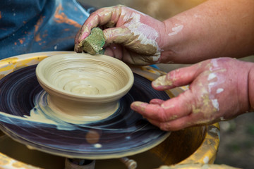 Ukrainian pottery.Creating a sculpture of clay close-up. Hands making products from clay. Pottery museum in Ukrainian village Oposhnya, center of Ukrainian pottery production.