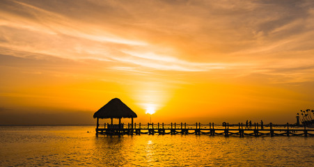 beautiful orange sunset on the sea with a pier