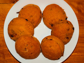 Pogacsa – homemade salty biscuits with bacon and fried onion on white plate