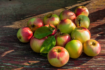 Fresh red apples on old wooden table 