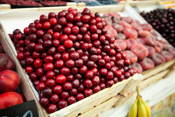 A lot of cherries in box on sale at farms market