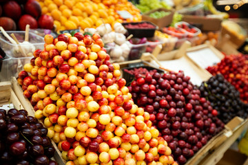 A lot of cherries in box on sale at farms market