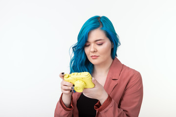 Photographer, hobby and leisure concept - Young woman with blue hair holding retro camera on white background with copy space