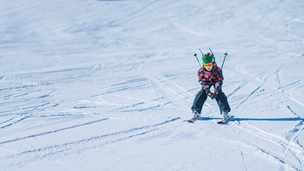 Fototapeta na wymiar Young Skier Skiing Down the Slope