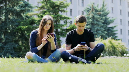 Dependent on the phone people who use the phone in the park, serious, cell phone addiction and mood
