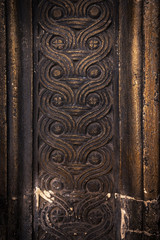 Naklejka premium Ancient columns with Renaissance bas-reliefs and plants patterns in the wall