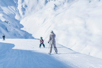 Fototapeta na wymiar Mother and Son Skiing Together
