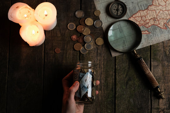 person holding a jar full of coins wonderingwich is going to be the next ravel destination