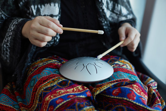Asian women pounding instruments - 'empty drums' ,in airport, On the journey