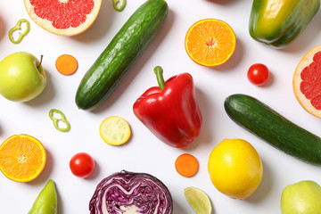 Different vegetables and fruits on white background, top view