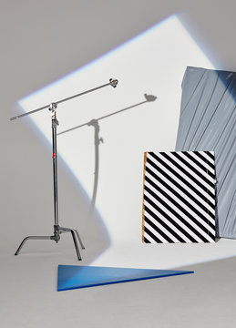 A rectangle shaped spotlight shining on still life props in a photography studio.