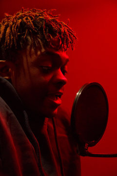 Black man performing song in studio