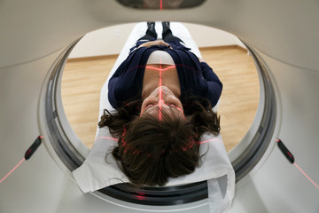 Clinic: Laser Guide Projected Onto Woman's Head For Scan