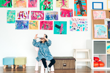 Preshool kids wearing virtual reality headset in classroom