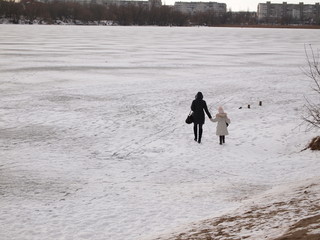 Woman and child on thin spring ice